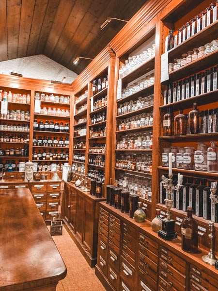 a room with shelves full of bottles in pharmacy