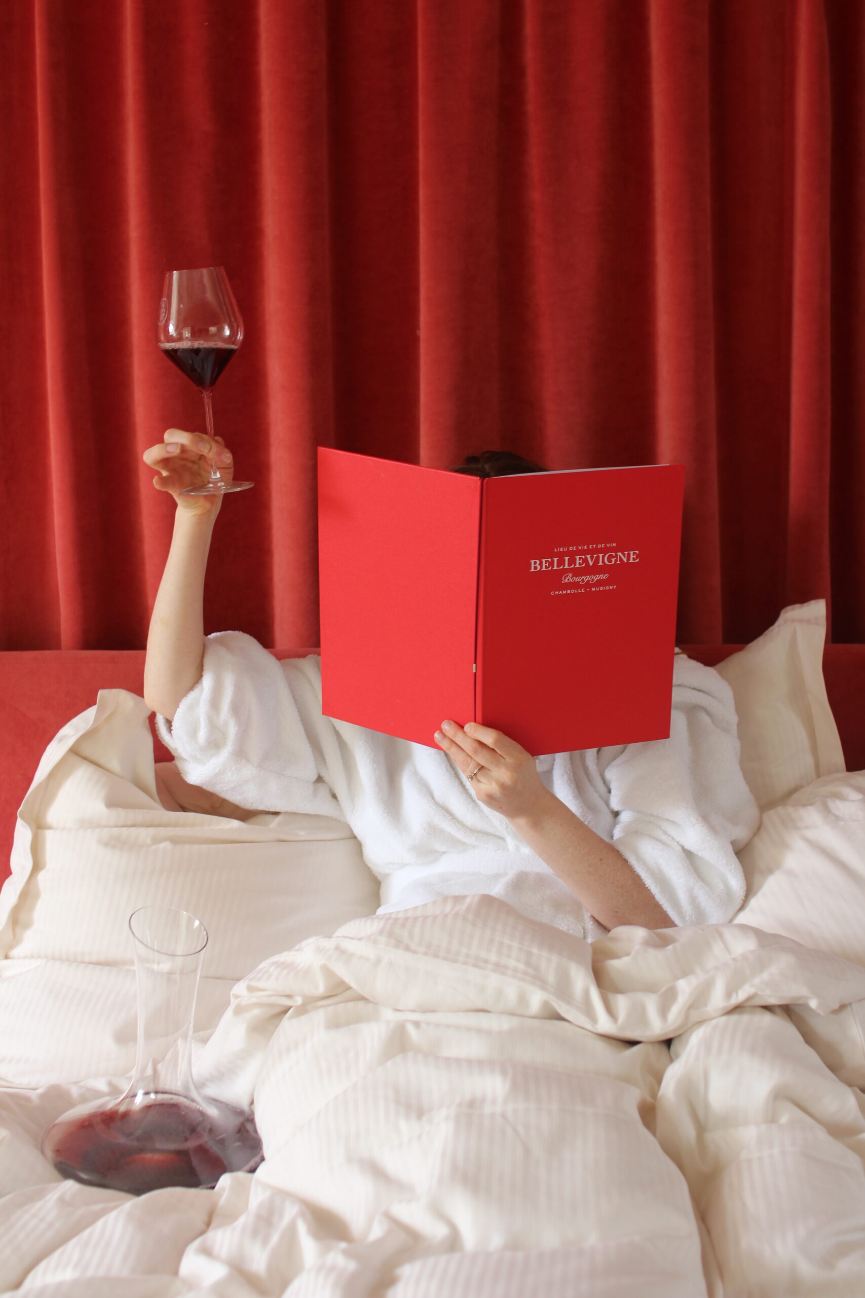 Reading with a glass of red Burgundy at Bellevigne